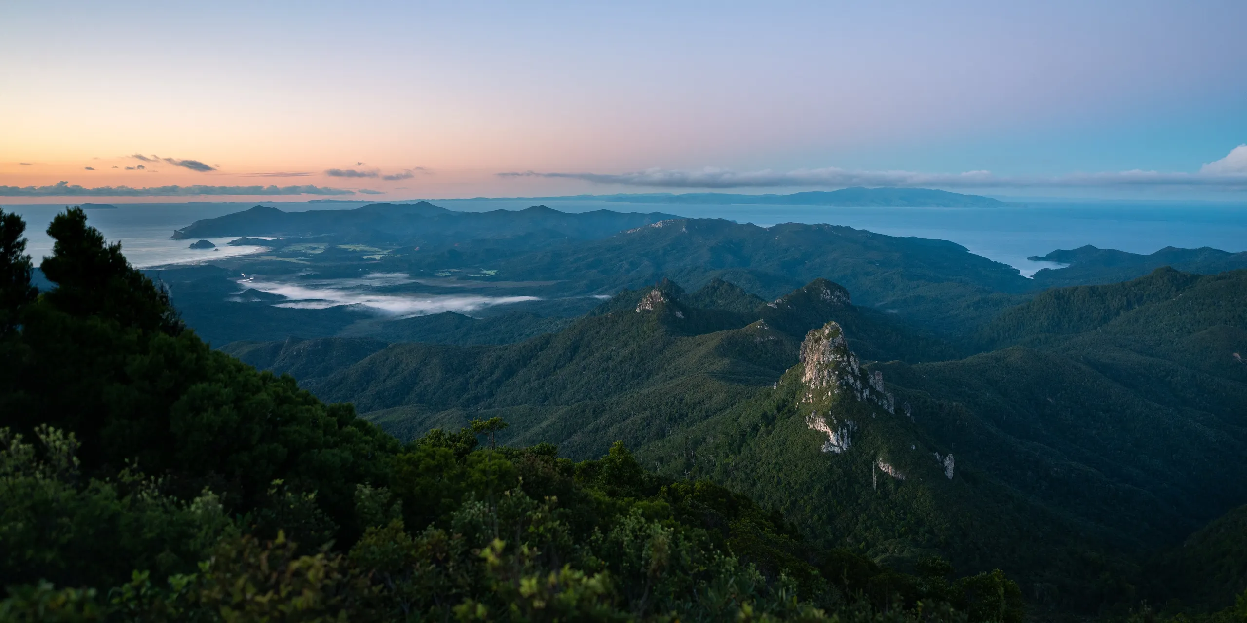 The first light brushes Mt Heale below us. The town of Claris sits beneath the fog to the left.