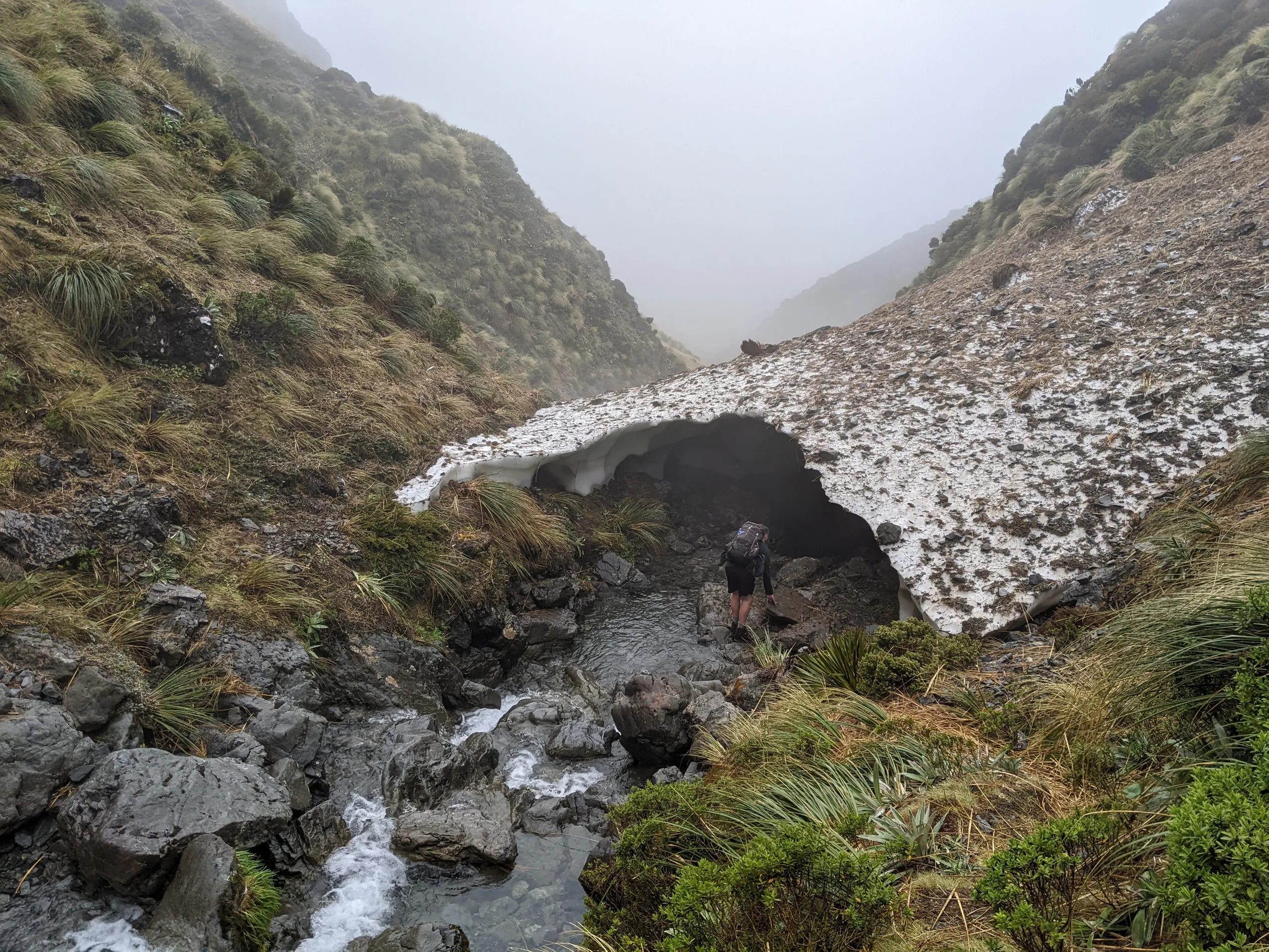 Avalanche debris snow cover over the stream draining from Tarn Col Tarn