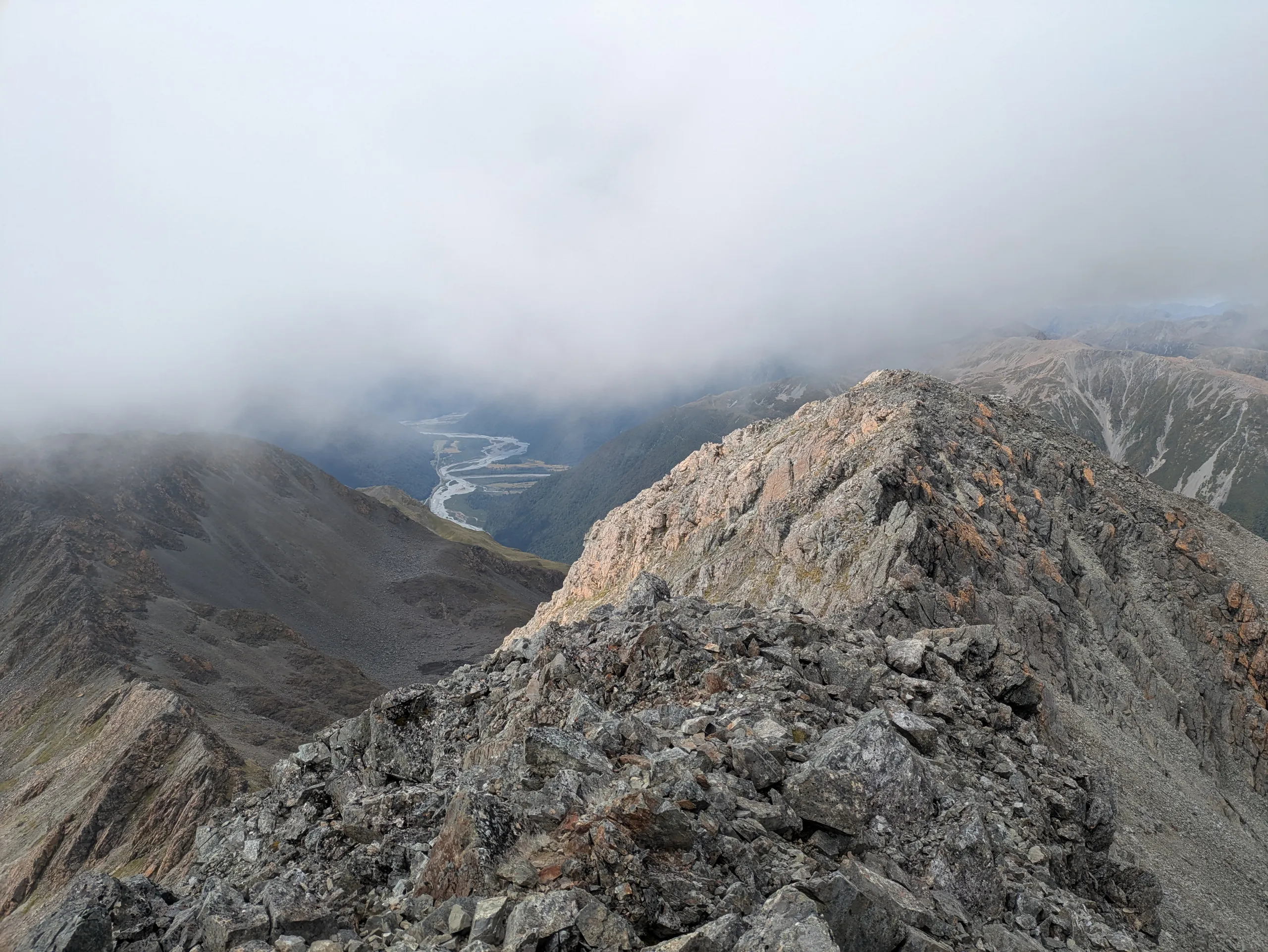 View from the summit looking past the low peak and along the Otira River