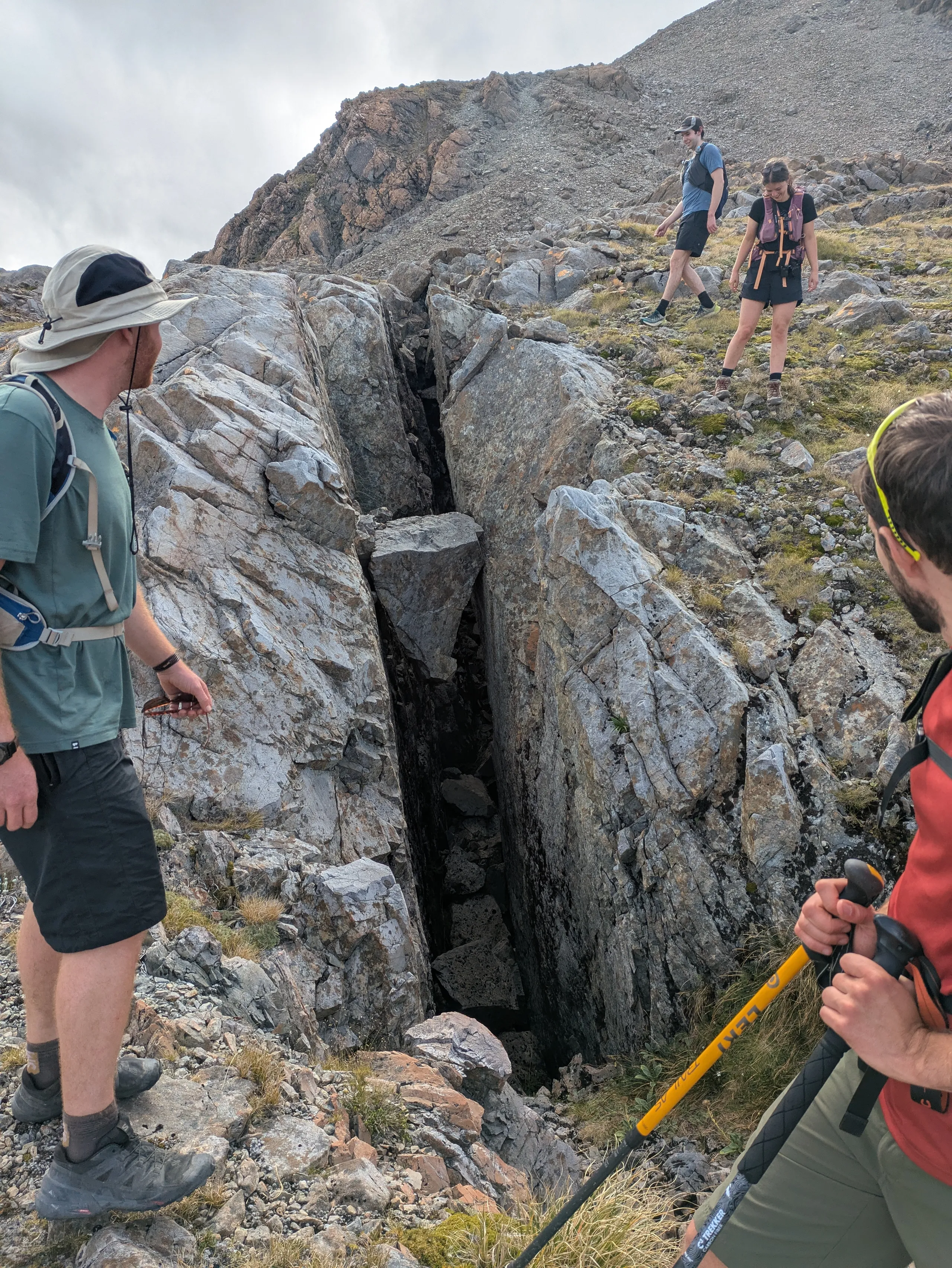 Triangular stone implausibly wedged in a ravine